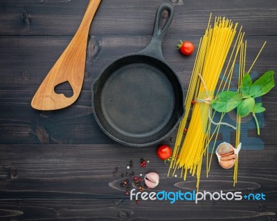 The Thin Spaghetti On Black Wooden Background. Yellow Italian Pa… Stock Photo