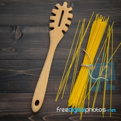 The Thin Spaghetti On Black Wooden Background. Yellow Italian Pa… Stock Photo