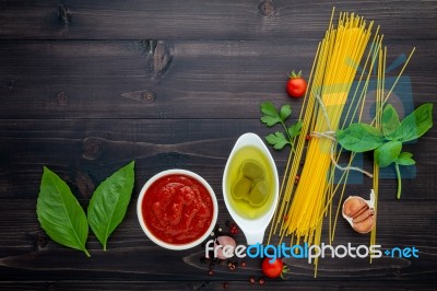 The Thin Spaghetti On Black Wooden Background. Yellow Italian Pa… Stock Photo