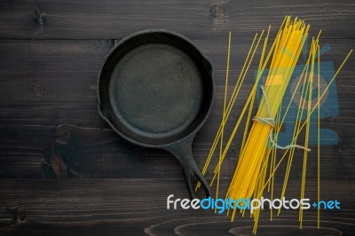 The Thin Spaghetti On Black Wooden Background. Yellow Italian Pa… Stock Photo