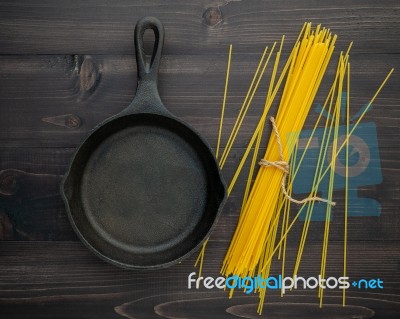 The Thin Spaghetti On Black Wooden Background. Yellow Italian Pa… Stock Photo