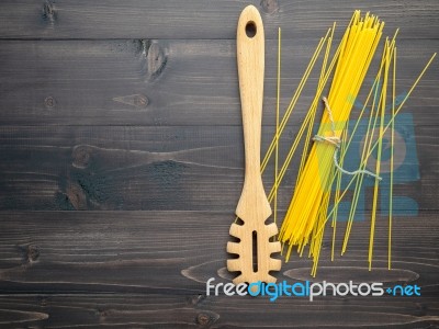 The Thin Spaghetti On Black Wooden Background. Yellow Italian Pa… Stock Photo