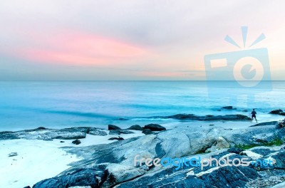 The View Of The Sand Beach And Sea Wave With Rock And Reef On Morning With Sunrise Stock Photo