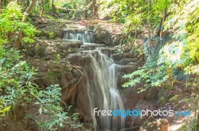 The Water Flowing Over Rocks And Trees Down A Waterfall At Huay Mae Khamin Waterfall National Park ,kanchana Buri In Thailand Stock Photo