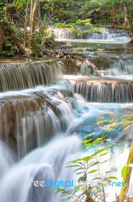 The Water Flowing Over Rocks And Trees Down A Waterfall At Huay Mae Khamin Waterfall National Park ,kanchana Buri In Thailand Stock Photo