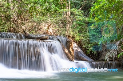 The Water Flowing Over Rocks And Trees Down A Waterfall At Huay Mae Khamin Waterfall National Park ,kanchana Buri In Thailand Stock Photo