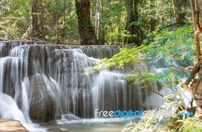 The Water Flowing Over Rocks And Trees Down A Waterfall At Huay Mae Khamin Waterfall National Park ,kanchana Buri In Thailand Stock Photo