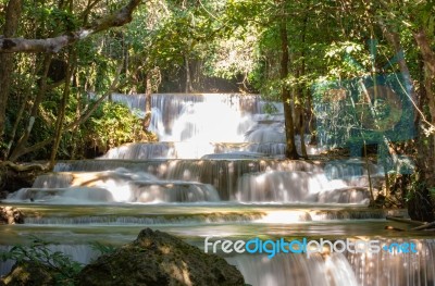 The Water Flowing Over Rocks And Trees Down A Waterfall At Huay Mae Khamin Waterfall National Park ,kanchana Buri In Thailand Stock Photo