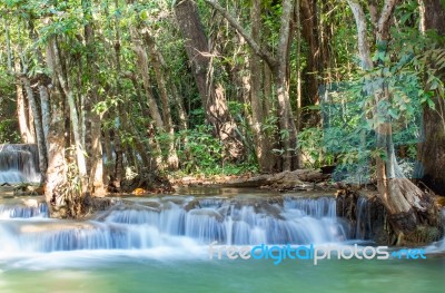 The Water Flowing Over Rocks And Trees Down A Waterfall At Huay Mae Khamin Waterfall National Park ,kanchana Buri In Thailand Stock Photo