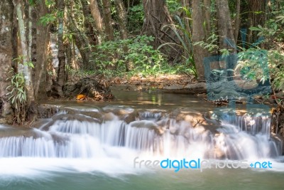 The Water Flowing Over Rocks And Trees Down A Waterfall At Huay Mae Khamin Waterfall National Park ,kanchana Buri In Thailand Stock Photo