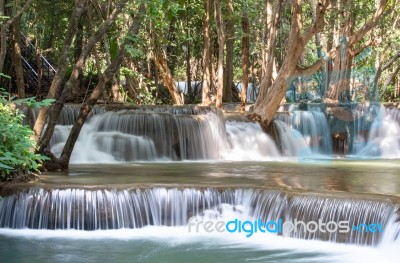 The Water Flowing Over Rocks And Trees Down A Waterfall At Huay Mae Khamin Waterfall National Park ,kanchana Buri In Thailand Stock Photo