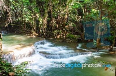 The Water Flowing Over Rocks And Trees Down A Waterfall At Huay Mae Khamin Waterfall National Park ,kanchana Buri In Thailand Stock Photo