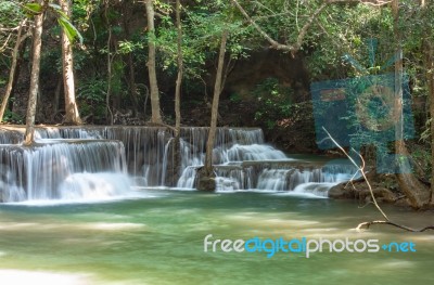 The Water Flowing Over Rocks And Trees Down A Waterfall At Huay Mae Khamin Waterfall National Park ,kanchana Buri In Thailand Stock Photo