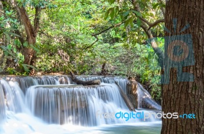 The Water Flowing Over Rocks And Trees Down A Waterfall At Huay Mae Khamin Waterfall National Park ,kanchana Buri In Thailand Stock Photo