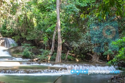 The Water Flowing Over Rocks And Trees Down A Waterfall At Huay Mae Khamin Waterfall National Park ,kanchana Buri In Thailand Stock Photo