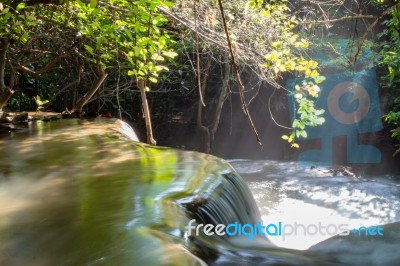 The Water Flowing Over Rocks And Trees Down A Waterfall At Huay Mae Khamin Waterfall National Park ,kanchana Buri In Thailand Stock Photo