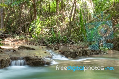 The Water Flowing Over Rocks And Trees Down A Waterfall At Huay Mae Khamin Waterfall National Park ,kanchana Buri In Thailand Stock Photo