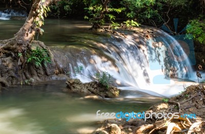 The Water Flowing Over Rocks And Trees Down A Waterfall At Huay Mae Khamin Waterfall National Park ,kanchana Buri In Thailand Stock Photo