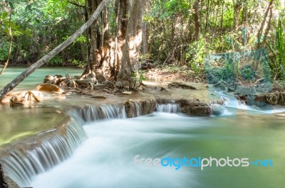 The Water Flowing Over Rocks And Trees Down A Waterfall At Huay Mae Khamin Waterfall National Park ,kanchana Buri In Thailand Stock Photo