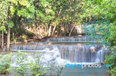 The Water Flowing Over Rocks And Trees Down A Waterfall At Huay Mae Khamin Waterfall National Park ,kanchana Buri In Thailand Stock Photo