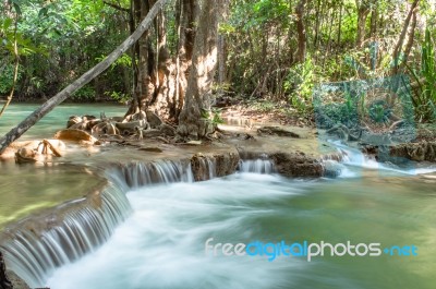 The Water Flowing Over Rocks And Trees Down A Waterfall At Huay Mae Khamin Waterfall National Park ,kanchana Buri In Thailand Stock Photo