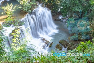 The Water Flowing Over Rocks And Trees Down A Waterfall At Huay Mae Khamin Waterfall National Park ,kanchana Buri In Thailand Stock Photo