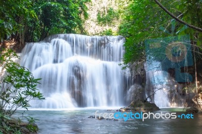 The Water Flowing Over Rocks And Trees Down A Waterfall At Huay Mae Khamin Waterfall National Park ,kanchana Buri In Thailand Stock Photo