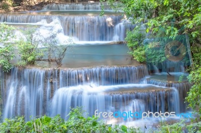 The Water Flowing Over Rocks And Trees Down A Waterfall At Huay Mae Khamin Waterfall National Park ,kanchana Buri In Thailand Stock Photo