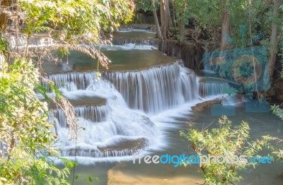 The Water Flowing Over Rocks And Trees Down A Waterfall At Huay Mae Khamin Waterfall National Park ,kanchana Buri In Thailand Stock Photo