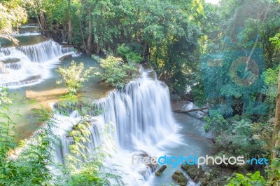 The Water Flowing Over Rocks And Trees Down A Waterfall At Huay Mae Khamin Waterfall National Park ,kanchana Buri In Thailand Stock Photo