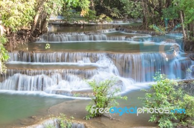 The Water Flowing Over Rocks And Trees Down A Waterfall At Huay Mae Khamin Waterfall National Park ,kanchana Buri In Thailand Stock Photo