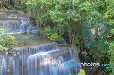 The Water Flowing Over Rocks And Trees Down A Waterfall At Huay Mae Khamin Waterfall National Park ,kanchana Buri In Thailand Stock Photo