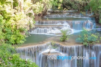 The Water Flowing Over Rocks And Trees Down A Waterfall At Huay Mae Khamin Waterfall National Park ,kanchana Buri In Thailand Stock Photo