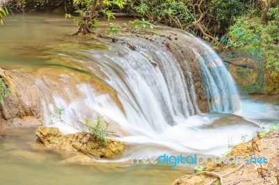 The Water Flowing Over Rocks And Trees Down A Waterfall At Huay Mae Khamin Waterfall National Park ,kanchana Buri In Thailand Stock Photo