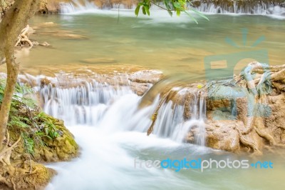 The Water Flowing Over Rocks And Trees Down A Waterfall At Huay Mae Khamin Waterfall National Park ,kanchana Buri In Thailand Stock Photo