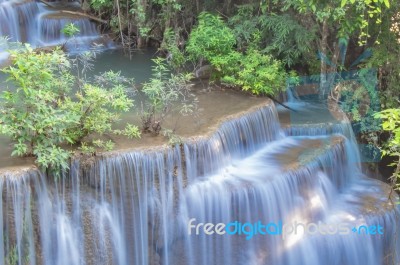 The Water Flowing Over Rocks And Trees Down A Waterfall At Huay Mae Khamin Waterfall National Park ,kanchana Buri In Thailand Stock Photo