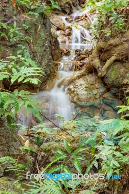 The Water Flowing Over Rocks And Trees Down A Waterfall At Huay Mae Khamin Waterfall National Park ,kanchana Buri In Thailand Stock Photo