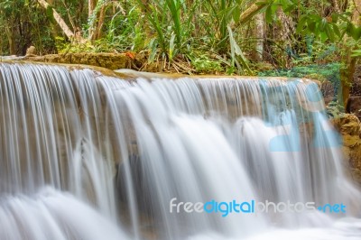 The Water Flowing Over Rocks And Trees Down A Waterfall At Huay Mae Khamin Waterfall National Park ,kanchana Buri In Thailand Stock Photo