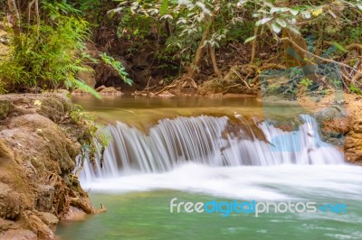 The Water Flowing Over Rocks And Trees Down A Waterfall At Huay Mae Khamin Waterfall National Park ,kanchana Buri In Thailand Stock Photo