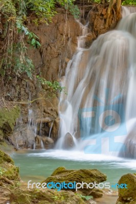 The Water Flowing Over Rocks And Trees Down A Waterfall At Huay Mae Khamin Waterfall National Park ,kanchana Buri In Thailand Stock Photo