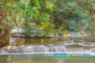 The Water Flowing Over Rocks And Trees Down A Waterfall At Huay Mae Khamin Waterfall National Park ,kanchana Buri In Thailand Stock Photo