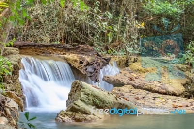 The Water Flowing Over Rocks And Trees Down A Waterfall At Huay Mae Khamin Waterfall National Park ,kanchana Buri In Thailand Stock Photo