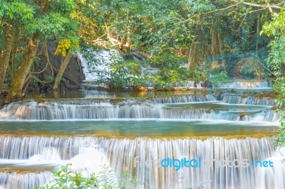 The Water Flowing Over Rocks And Trees Down A Waterfall At Huay Mae Khamin Waterfall National Park ,kanchana Buri In Thailand Stock Photo