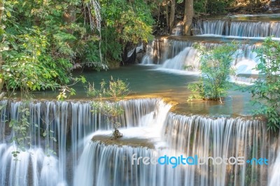 The Water Flowing Over Rocks And Trees Down A Waterfall At Huay Mae Khamin Waterfall National Park ,kanchana Buri In Thailand Stock Photo