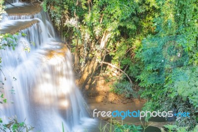 The Water Flowing Over Rocks And Trees Down A Waterfall At Huay Mae Khamin Waterfall National Park ,kanchana Buri In Thailand Stock Photo