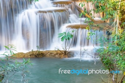 The Water Flowing Over Rocks And Trees Down A Waterfall At Huay Mae Khamin Waterfall National Park ,kanchana Buri In Thailand Stock Photo