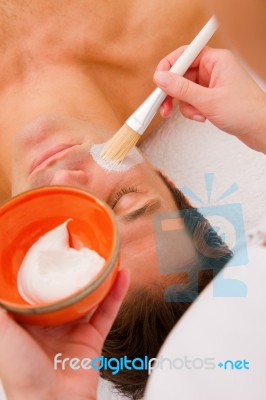 Therapist Applying Cream Man's Face Stock Photo