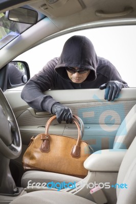 Thief Stealing Handbag From Car Stock Photo