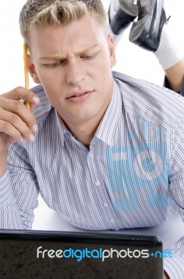 Thinking Man With Laptop And Pencil Stock Photo