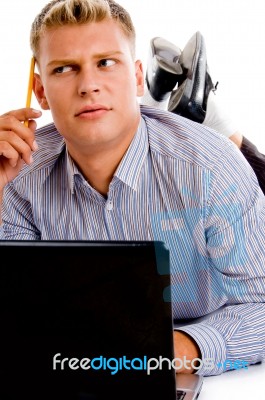 Thinking Man With Laptop And Pencil Stock Photo